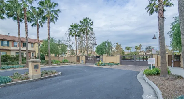a front view of multi story residential apartment building with yard and sign board
