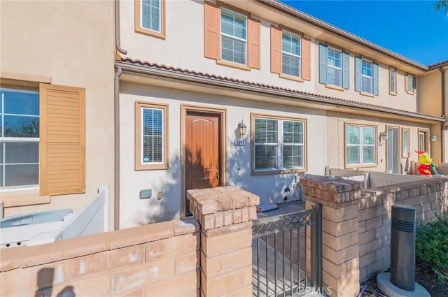 a living room filled with furniture and large windows