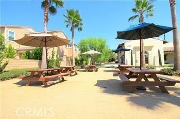 a view of a swimming pool with a table and chairs under an umbrella