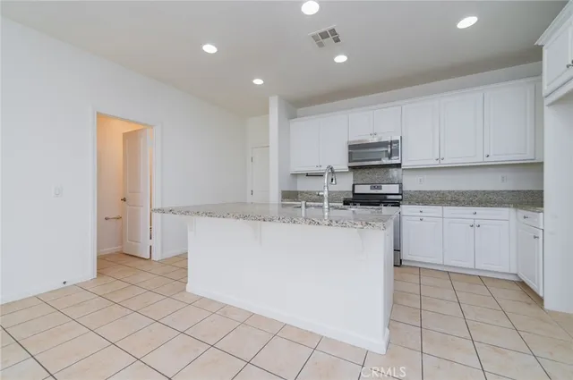 a kitchen with cabinets and white stainless steel appliances