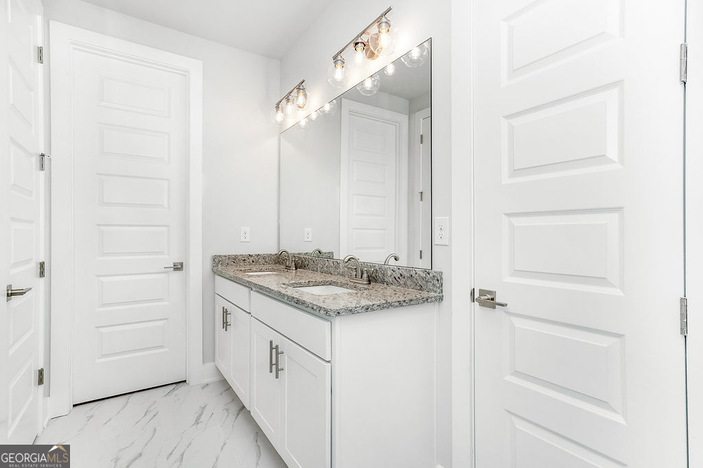 2604 Parkside Way Gainesville, GA 30507 - Photo 11 of 33 a bathroom with a granite countertop sink and a mirror