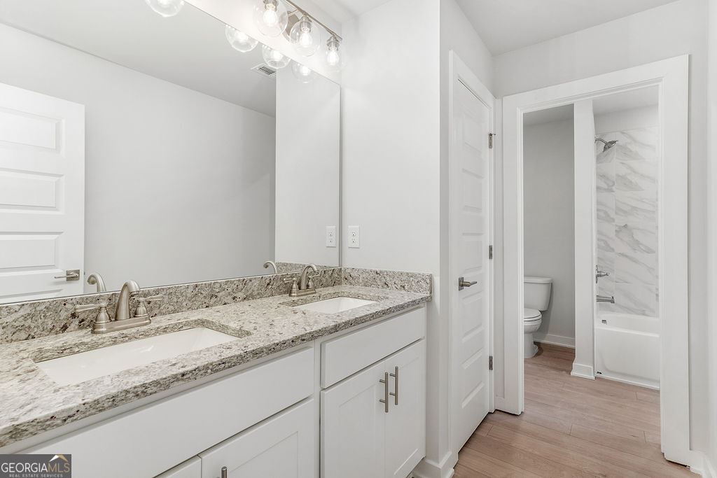 2604 Parkside Way Gainesville, GA 30507 - Photo 16 of 33 a bathroom with a granite countertop sink and a mirror