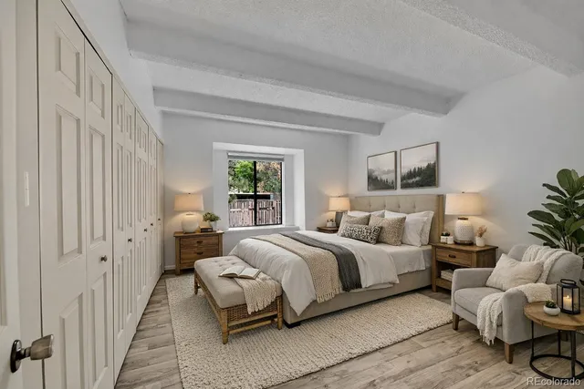 a spacious bedroom with a bed and a couch