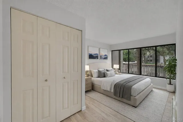 a bedroom with a large bed and a large window