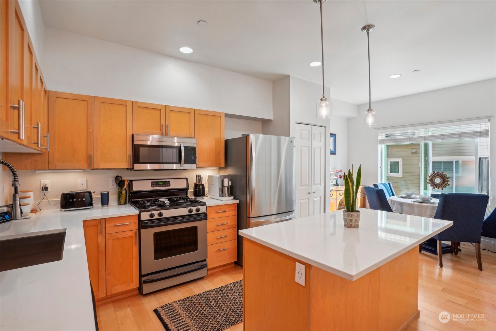 1127 Campbell Way Bremerton, WA 98310 - Photo 17 of 39 a kitchen with stainless steel appliances a stove a sink a refrigerator a dining table and chairs