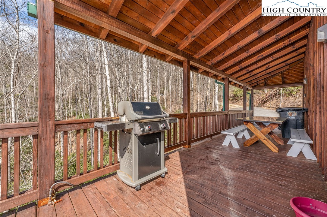 502 Poga Road Butler, TN 37640 - Photo 46 of 50 a view of a balcony with chairs and wooden floor