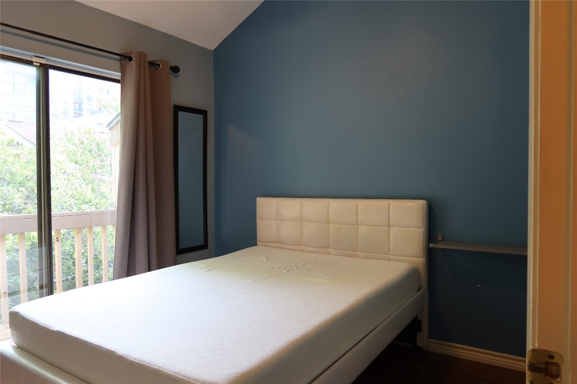 2210 Pearl Street, Unit 303 Austin, TX 78705 - Photo 13 of 23 a bed sitting in a bedroom next to a window