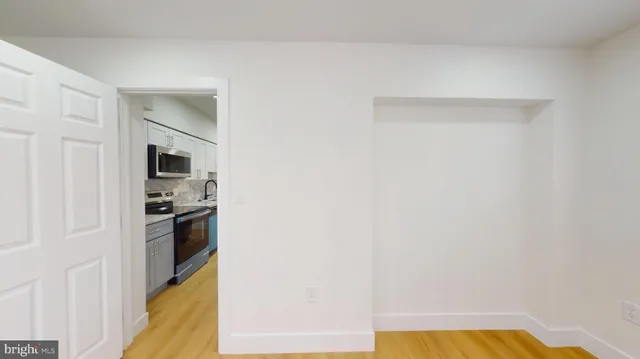 a view of a kitchen from the hallway