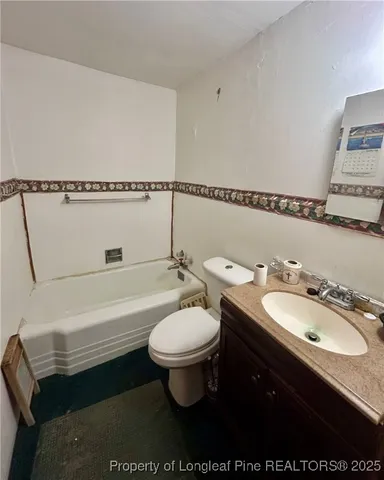 a bathroom with a sink toilet a mirror and bathtub