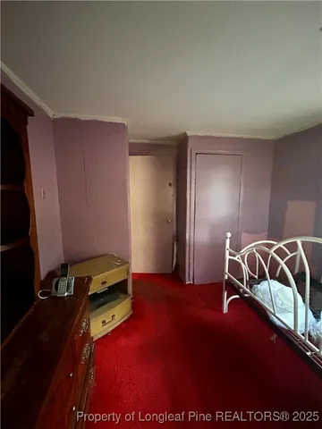 a bedroom with a bed and a desk