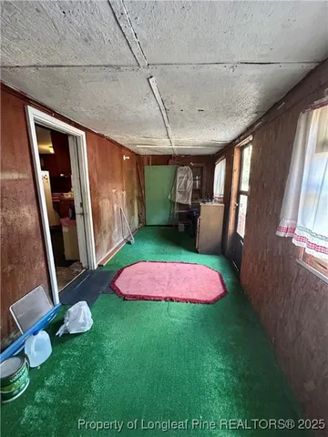 a view of a backyard with furniture and a yard