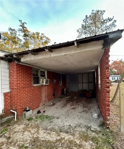 a view of a backyard with couches plants and large tree