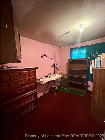 a living room with furniture a flat screen tv and gym equipment