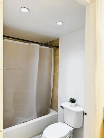 a white toilet sitting next to a bathroom sink