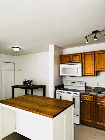 a kitchen that has a sink and a stove