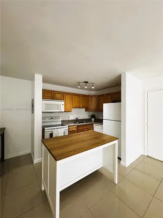 a kitchen with stainless steel appliances granite countertop a sink and a stove