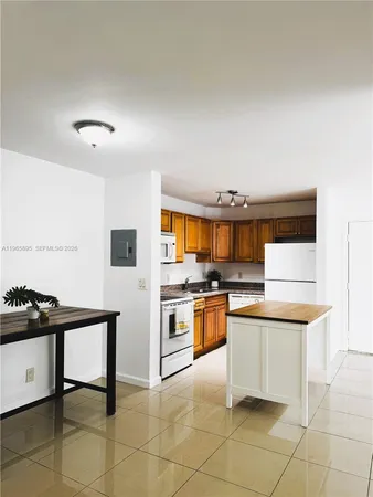 a kitchen with stainless steel appliances a stove a sink and a refrigerator