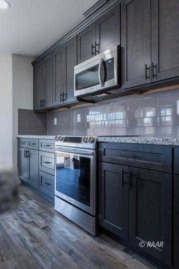 909 West Wasp Avenue Ridgecrest, CA 93555 - Photo 11 of 33 a kitchen with stainless steel appliances granite countertop a stove microwave and cabinets