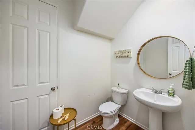 a bathroom with a toilet a sink and a mirror