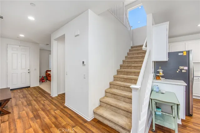 a view of entryway with furniture and wooden floor