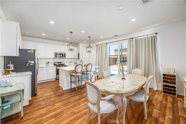 a dining room with furniture and wooden floor
