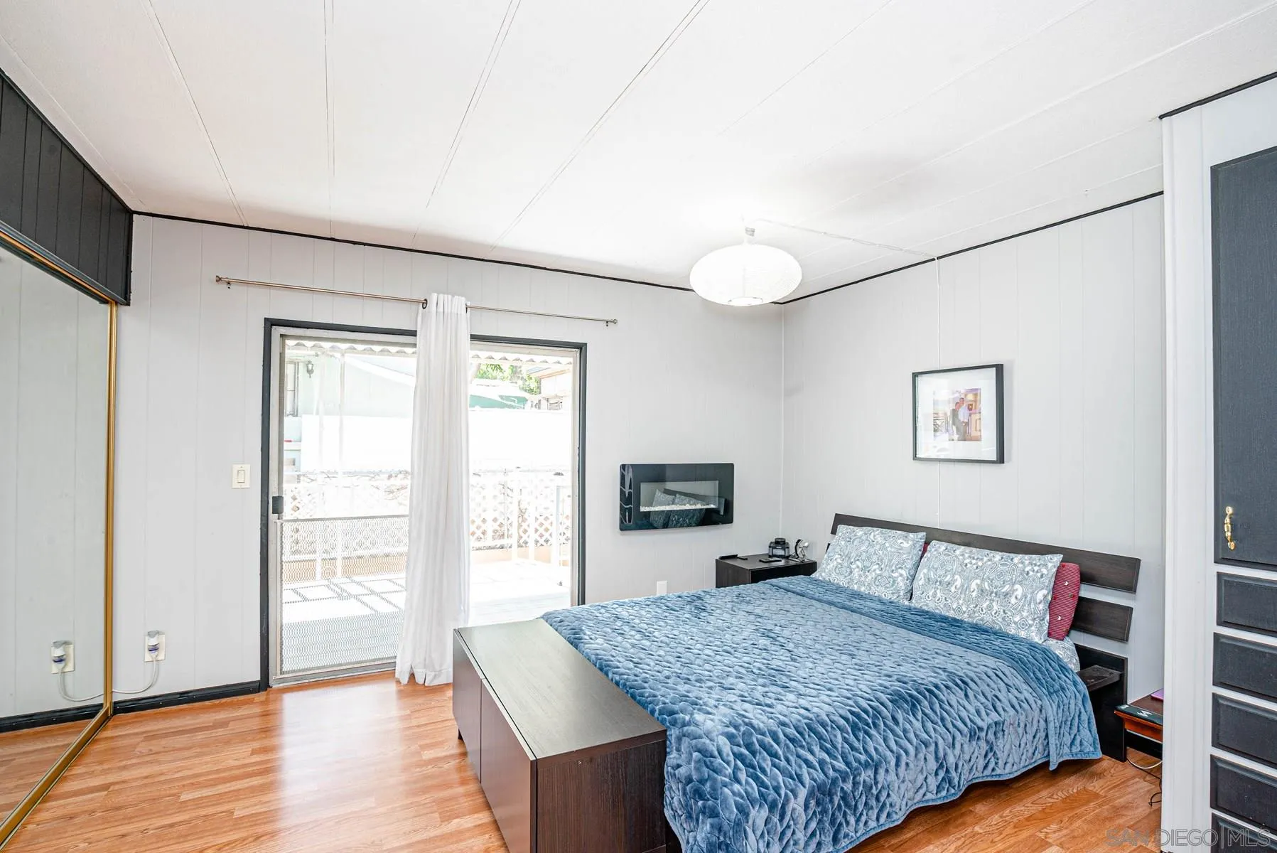 10880 Highway 67, Unit 17 Lakeside, CA 92040 - Photo 13 of 20 a bedroom with a large bed and wooden floor