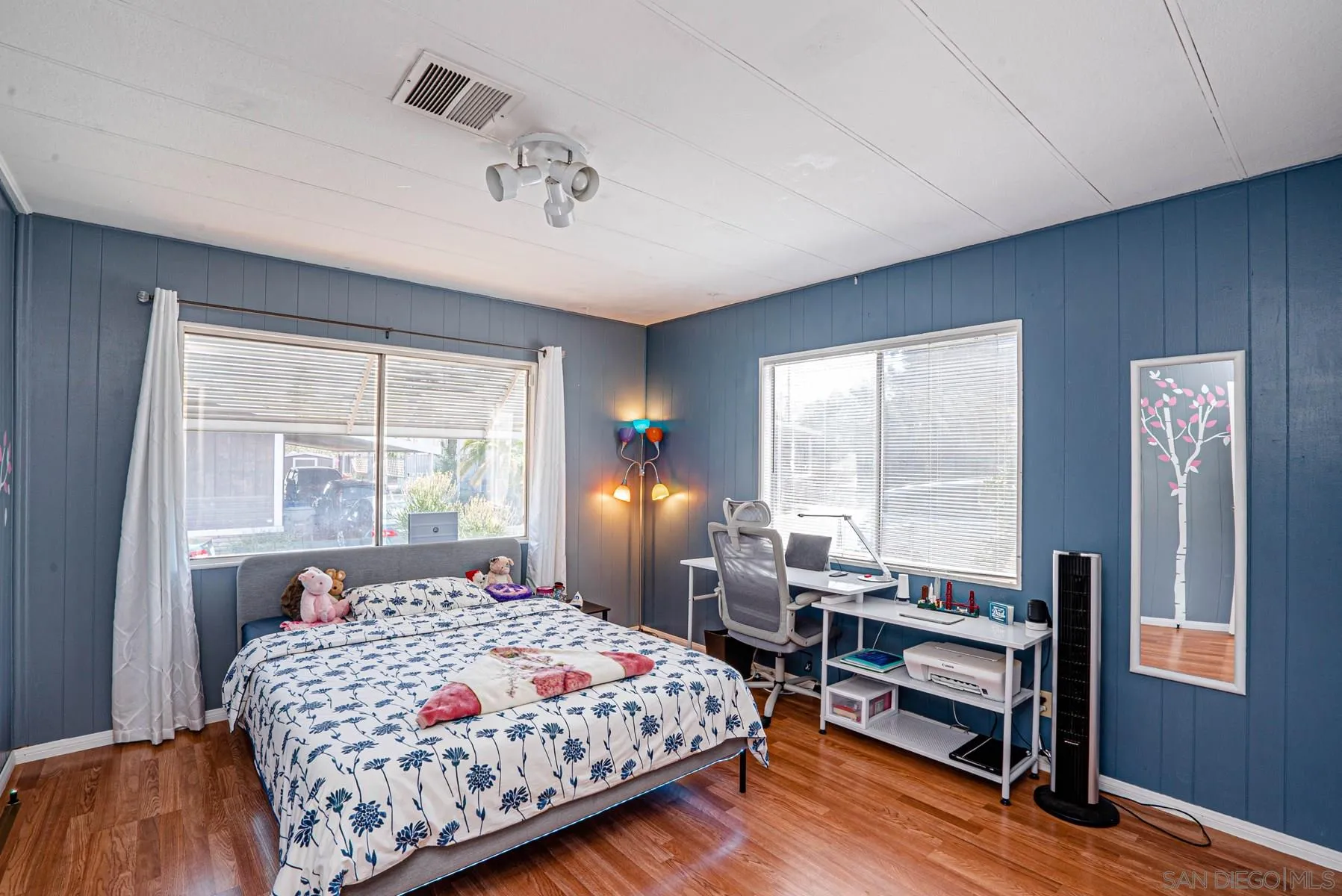 10880 Highway 67, Unit 17 Lakeside, CA 92040 - Photo 19 of 20 a bedroom with a bed wooden floor and lamp