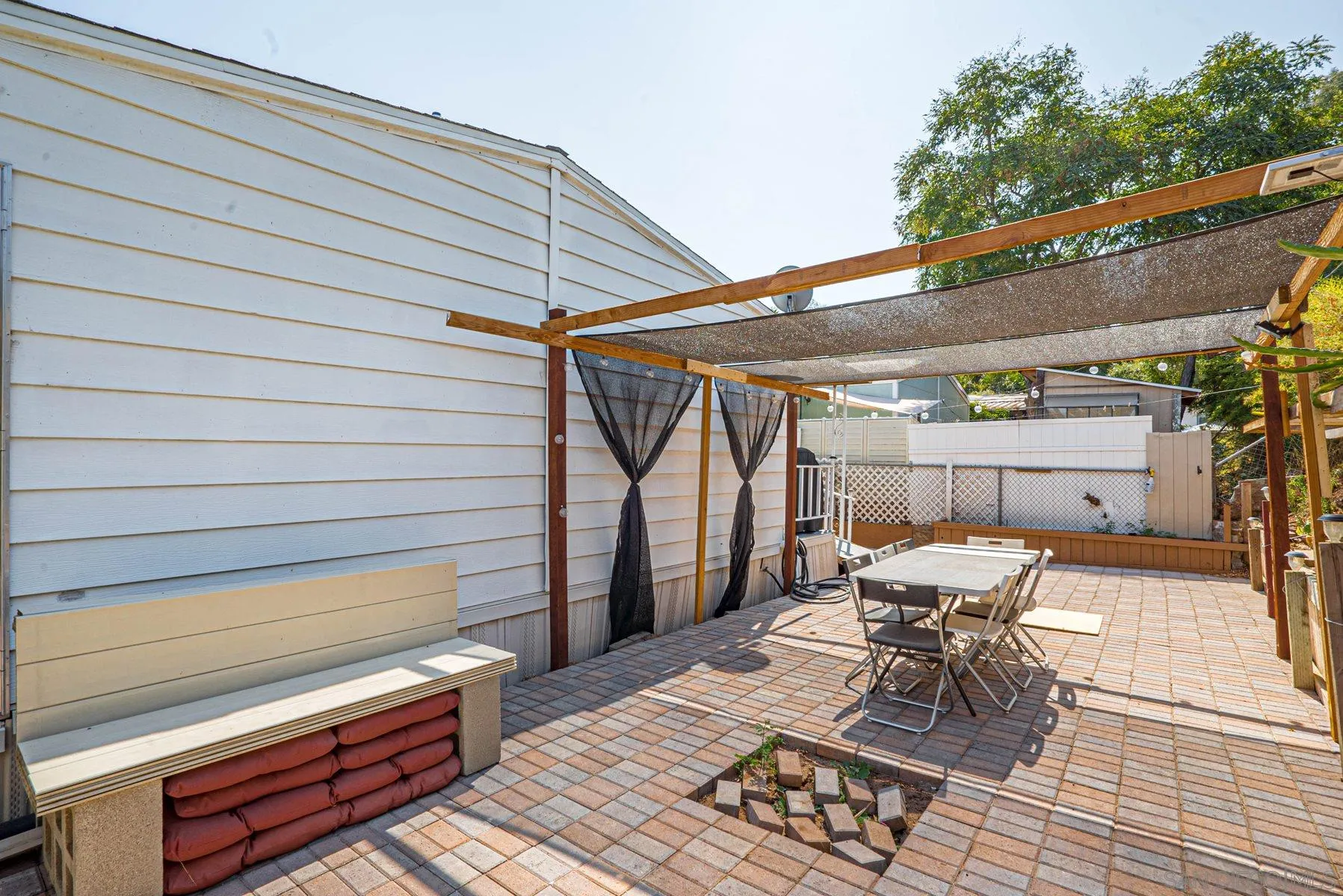 10880 Highway 67, Unit 17 Lakeside, CA 92040 - Photo 4 of 20 a patio with wooden floor a fire pit and furniture