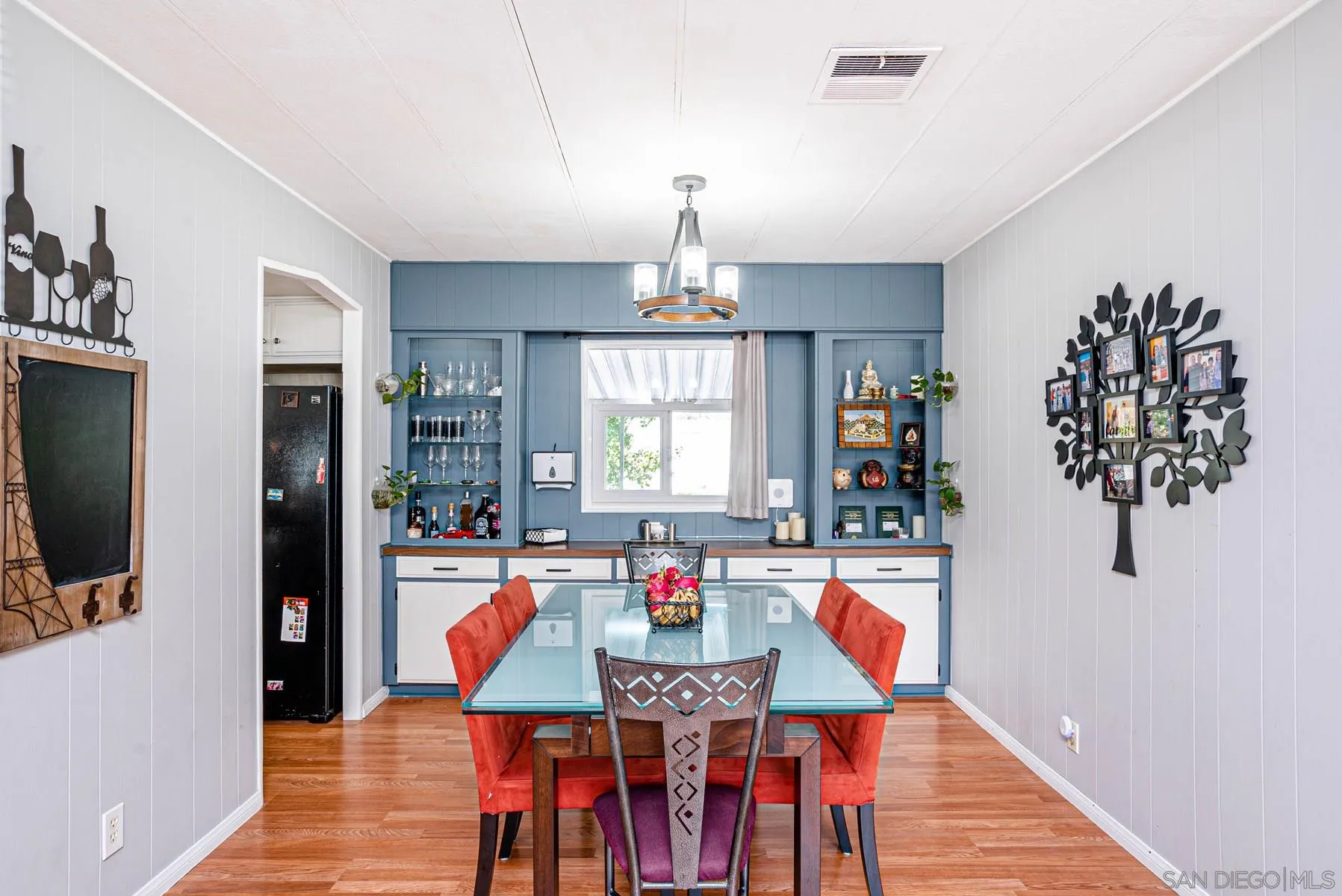 10880 Highway 67, Unit 17 Lakeside, CA 92040 - Photo 9 of 20 a dining room with furniture a chandelier and wooden floor
