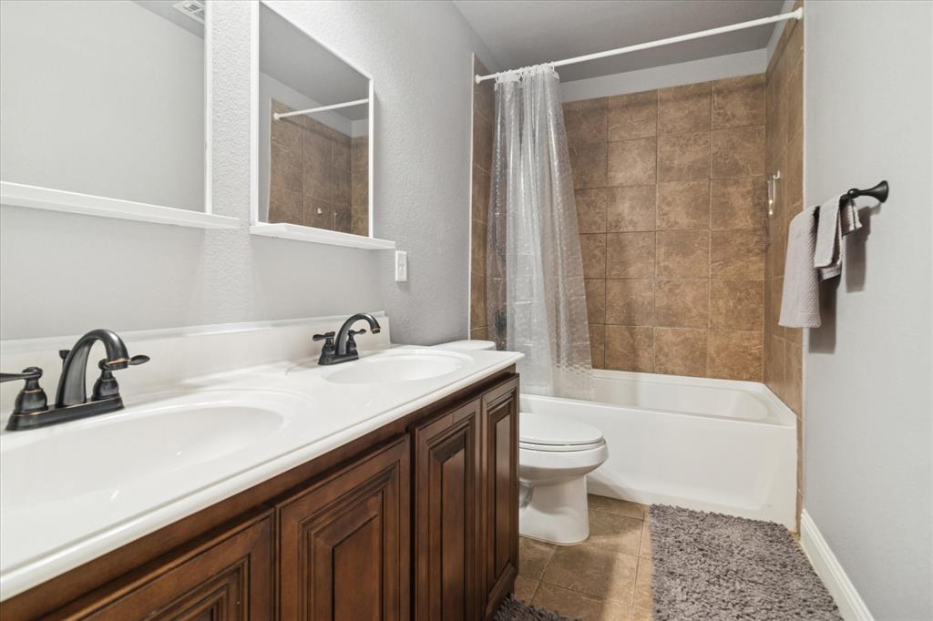 3605 Dogwood Road Melissa, TX 75454 - Photo 19 of 25 a bathroom with a sink a toilet a mirror and shower