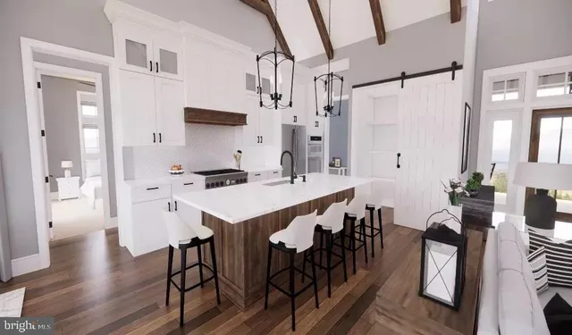 a kitchen with stainless steel appliances a table and chairs