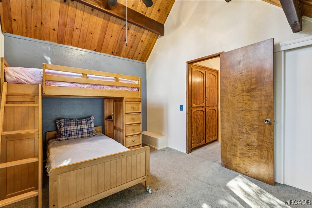 296 Massive Road Lake Arrowhead, CA 92352 - Photo 24 of 43 a bedroom with a bed and wooden floor