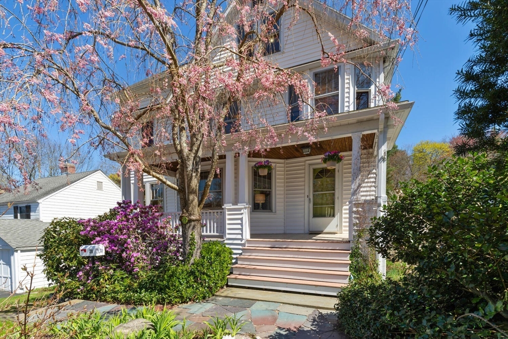 a front view of a house with a garden