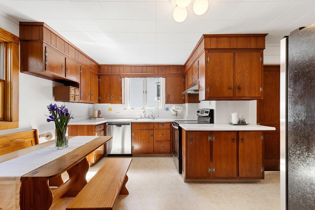 28 Spring Street Lexington, MA 02421 - Photo 11 of 39 a kitchen with stainless steel appliances granite countertop a sink and cabinets