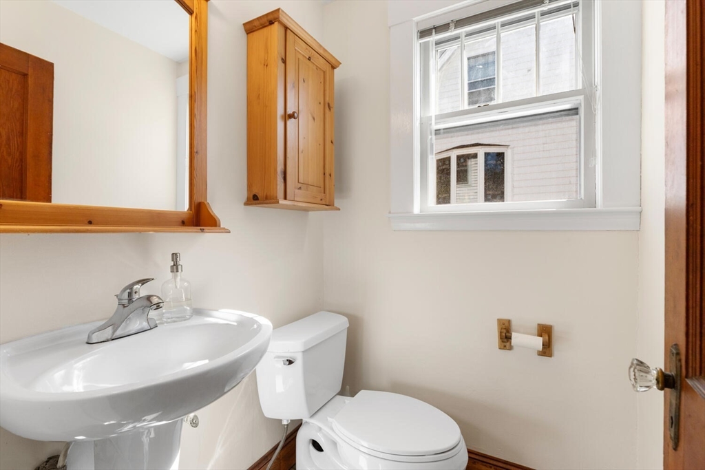 28 Spring Street Lexington, MA 02421 - Photo 15 of 39 a bathroom with a sink a toilet and mirror