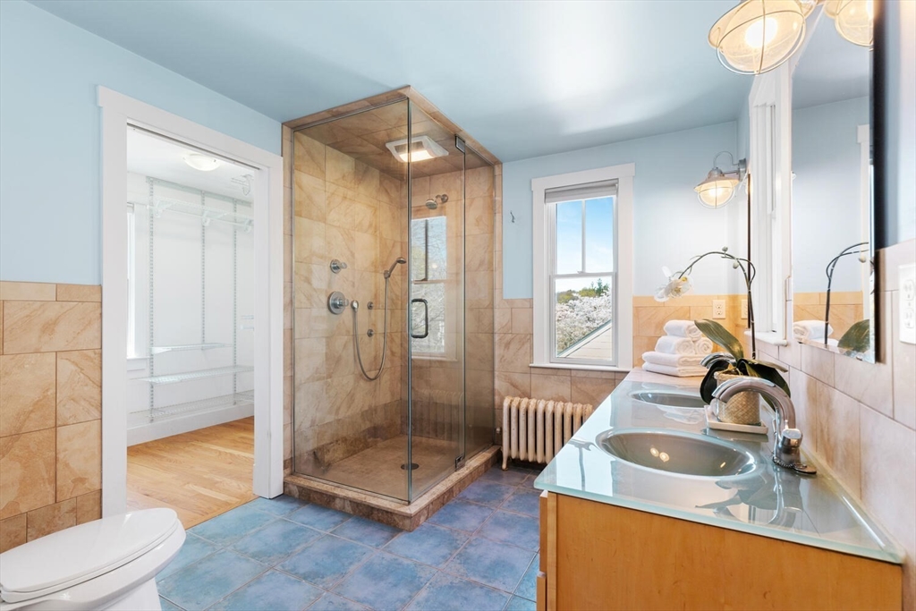 28 Spring Street Lexington, MA 02421 - Photo 18 of 39 a bathroom with a sink a toilet and shower