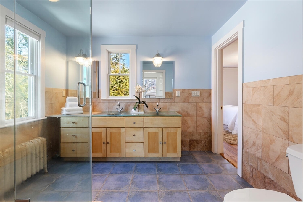 28 Spring Street Lexington, MA 02421 - Photo 19 of 39 a spacious bathroom with a double vanity sink a mirror and a bathtub