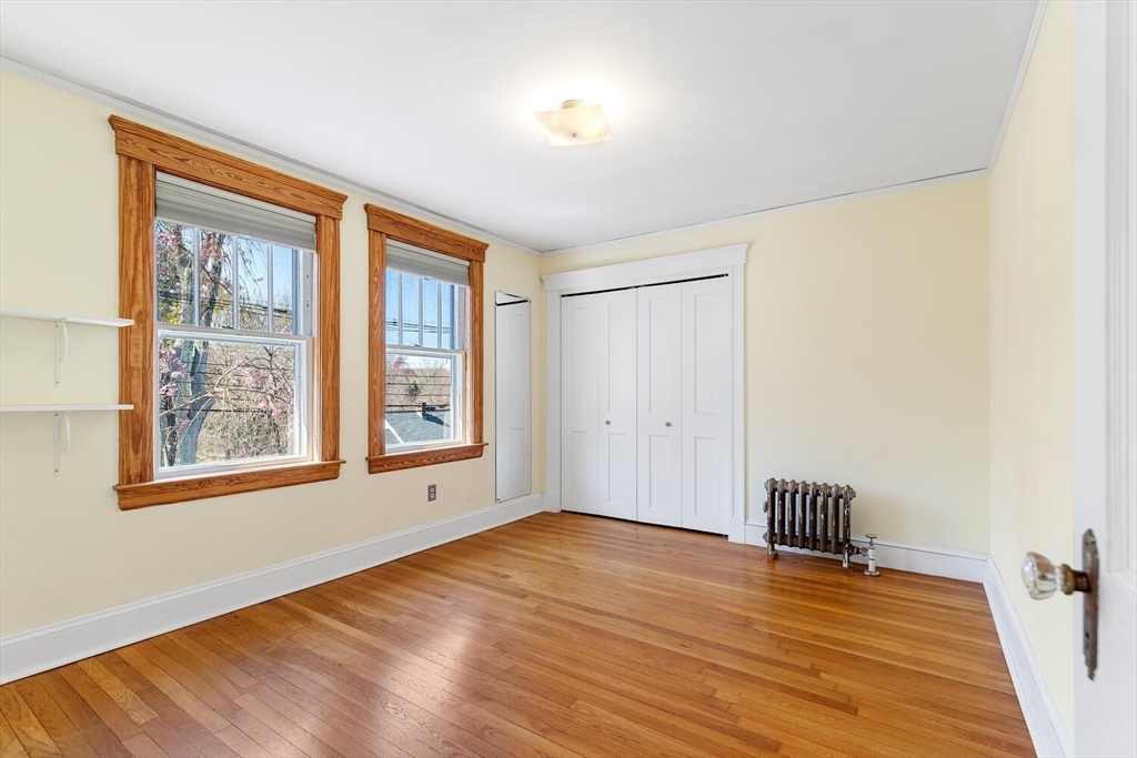 28 Spring Street Lexington, MA 02421 - Photo 21 of 39 a view of an empty room with wooden floor and a window