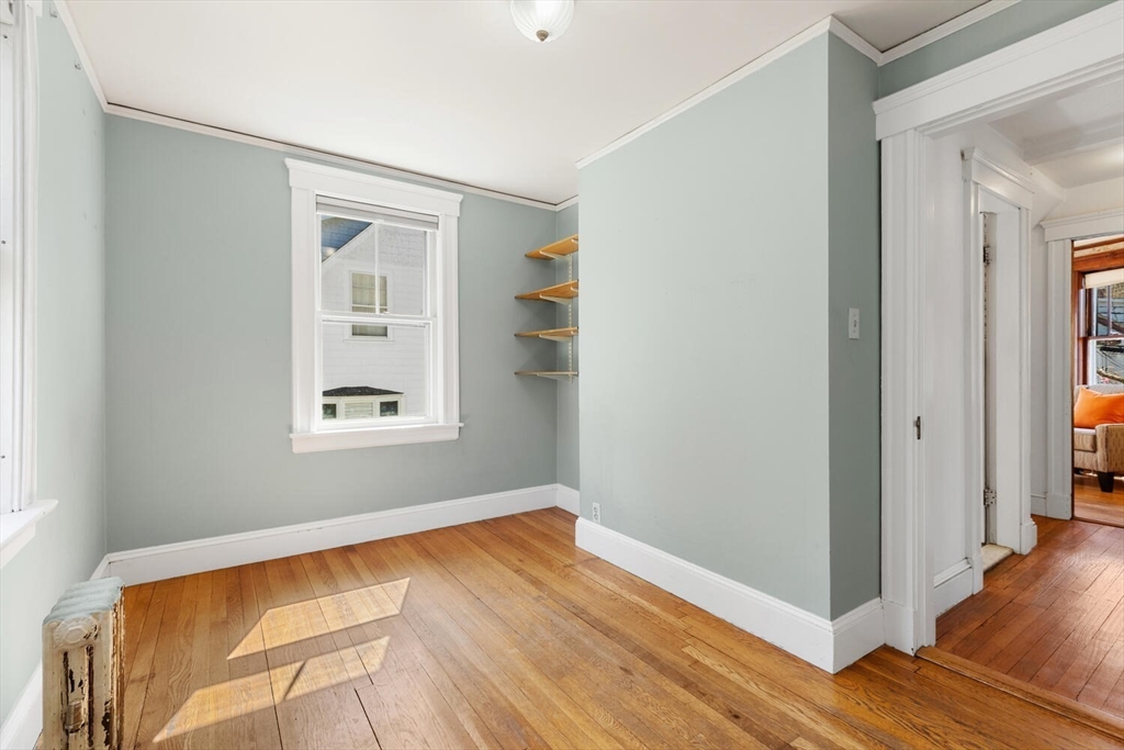 28 Spring Street Lexington, MA 02421 - Photo 22 of 39 a view of empty room with wooden floor and fan