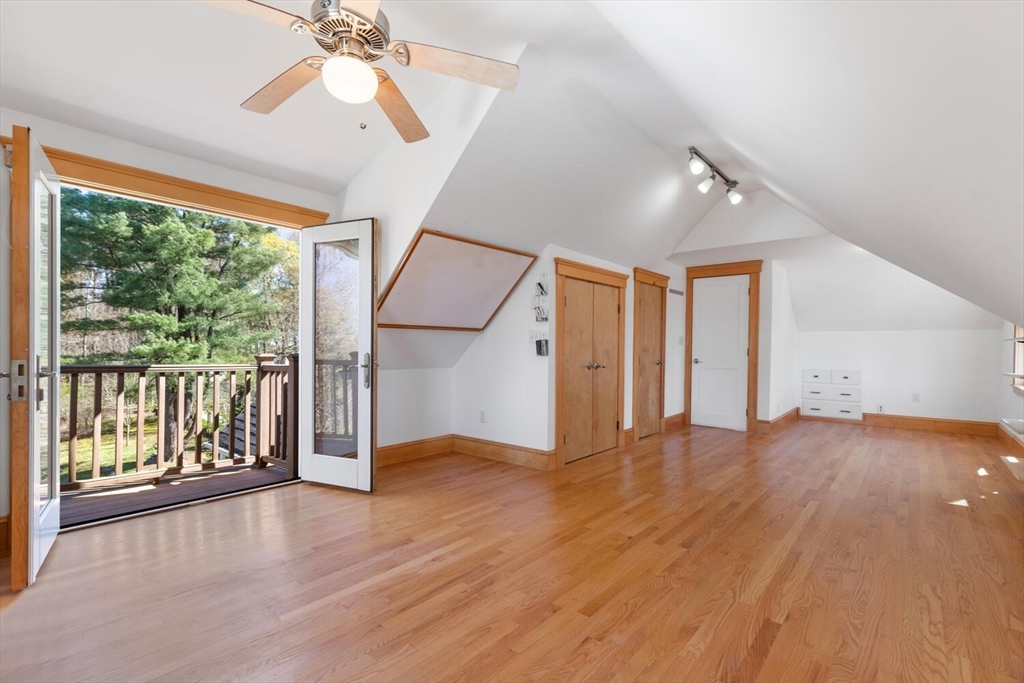 28 Spring Street Lexington, MA 02421 - Photo 26 of 39 a view of an empty room with wooden floor ceiling fan and windows