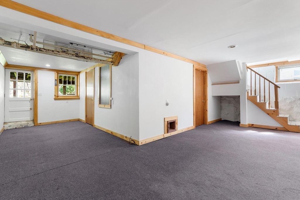 28 Spring Street Lexington, MA 02421 - Photo 29 of 39 a view of an empty room with wooden floor and a window