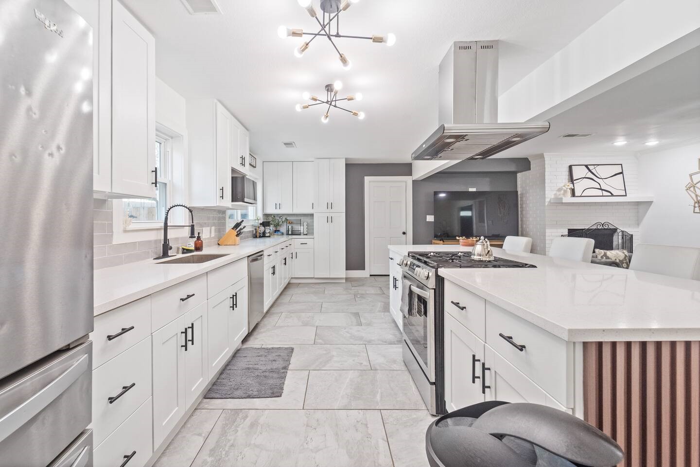 1206 Timber Lane Friendswood, TX 77546 - Photo 12 of 19 a large white kitchen with a large window a sink and stainless steel appliances