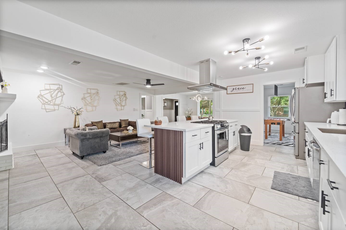 1206 Timber Lane Friendswood, TX 77546 - Photo 15 of 19 a kitchen with furniture a counter top space a sink stainless steel appliances and a chandelier