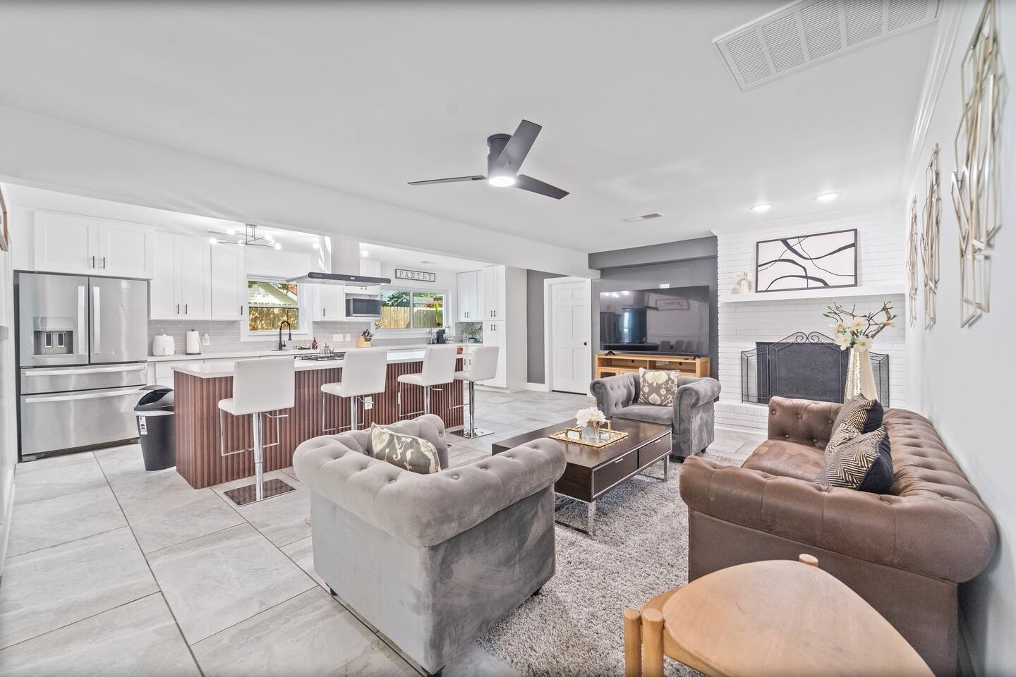 1206 Timber Lane Friendswood, TX 77546 - Photo 16 of 19 a living room with furniture a fireplace and a open kitchen view