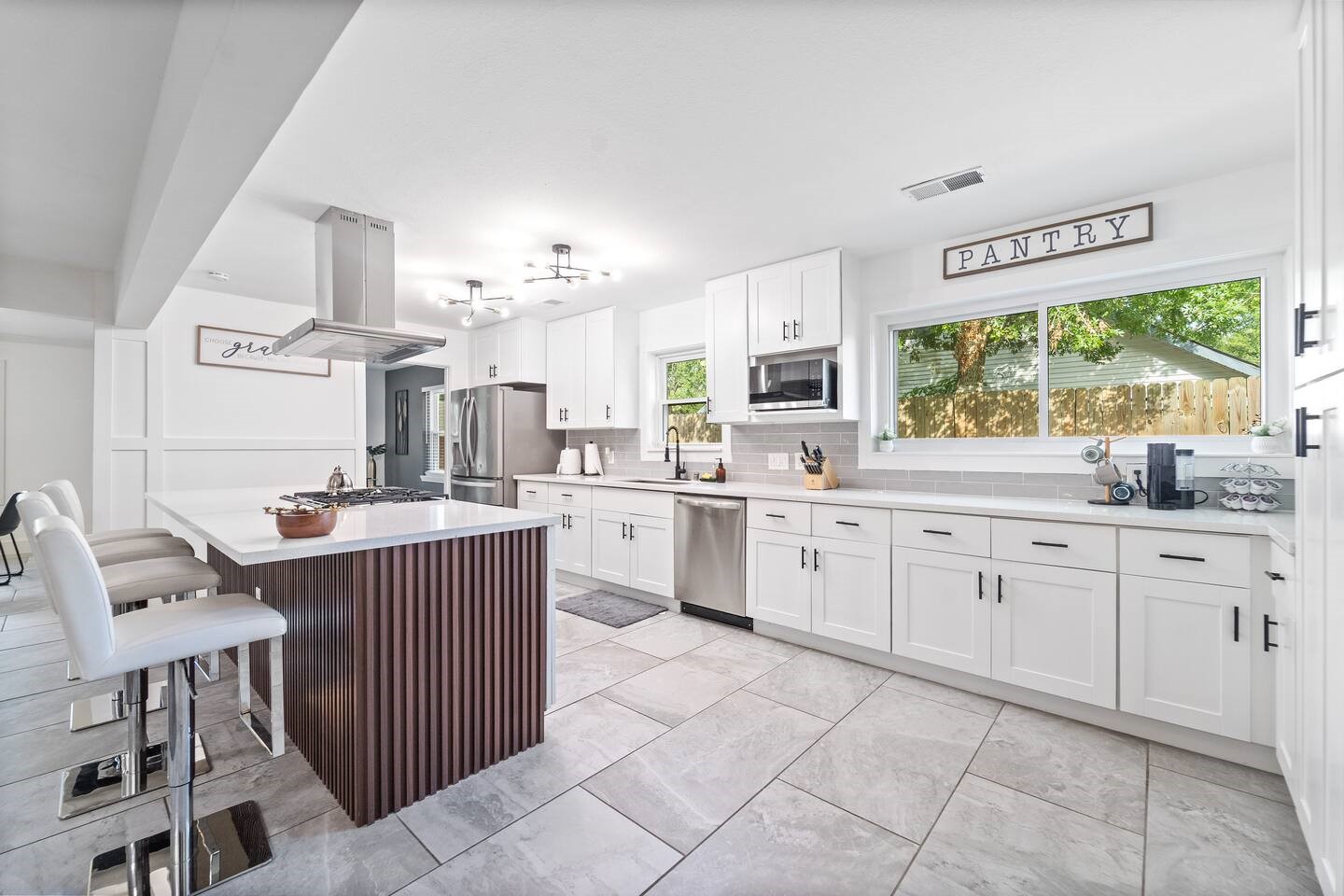 1206 Timber Lane Friendswood, TX 77546 - Photo 2 of 19 a kitchen with a sink stove top oven and microwave