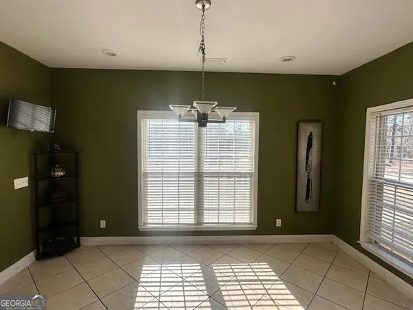 a view of empty room with window and fireplace