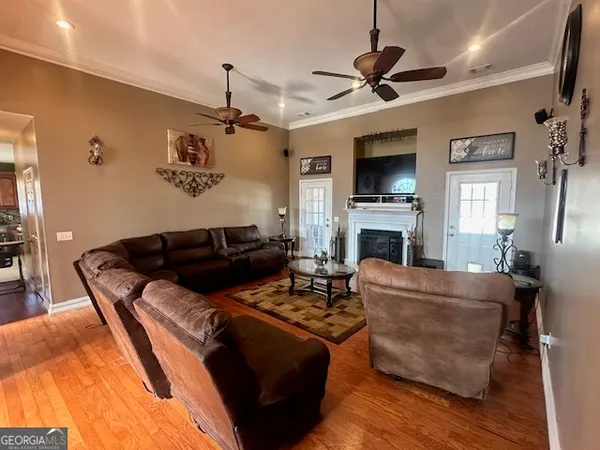 a living room with furniture a flat screen tv and a fireplace