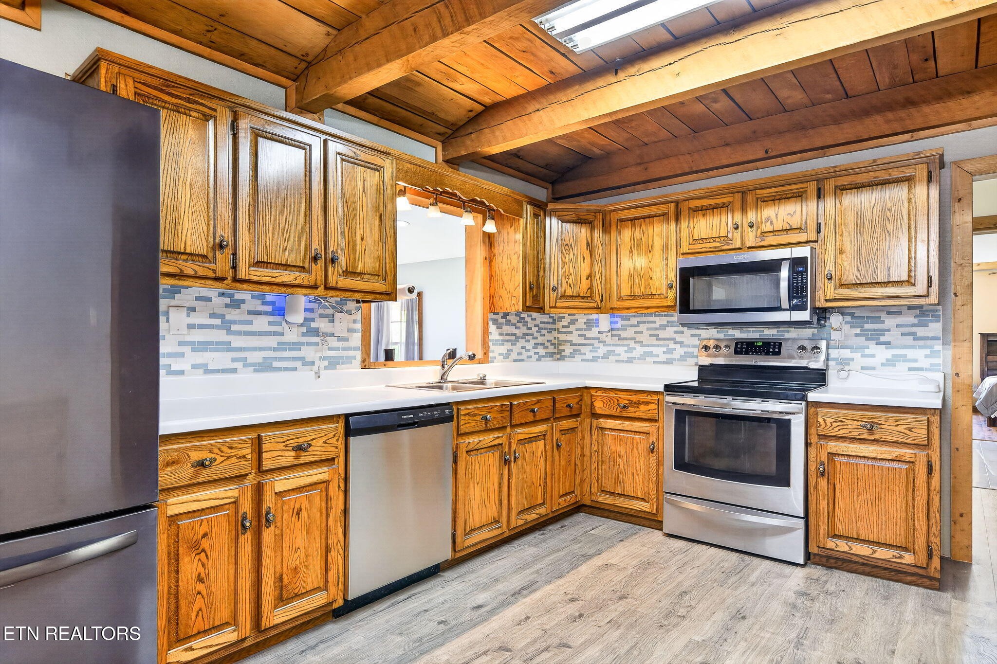 935 Brewer Road Crossville, TN 38572 - Photo 11 of 51 a kitchen with stainless steel appliances granite countertop wooden cabinets stove top oven and sink
