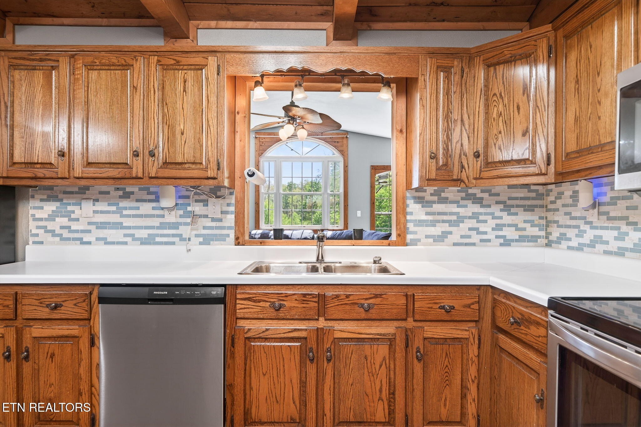 935 Brewer Road Crossville, TN 38572 - Photo 14 of 51 a kitchen with stainless steel appliances wooden cabinets a sink and a window