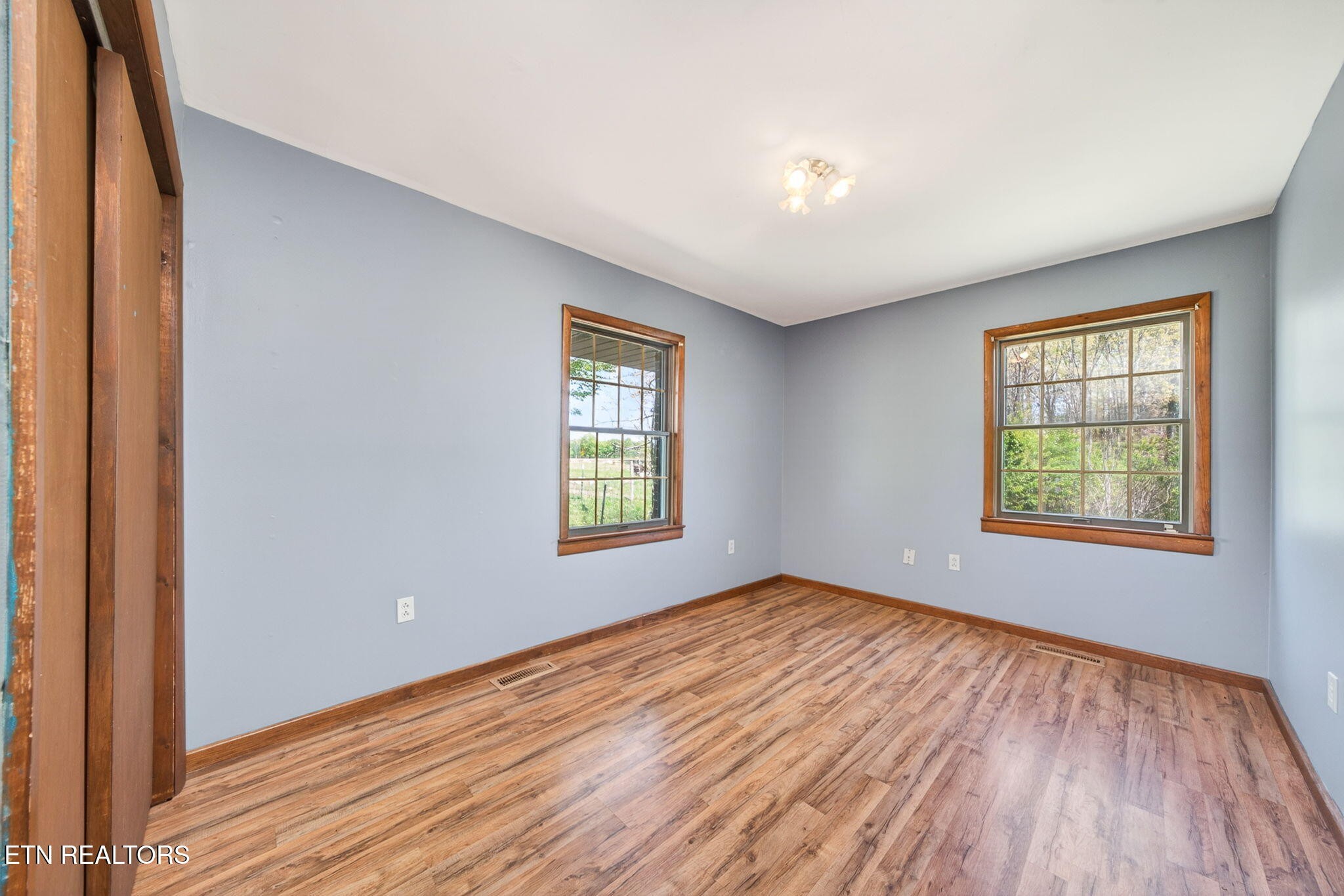 935 Brewer Road Crossville, TN 38572 - Photo 29 of 51 a view of an empty room with wooden floor and a window